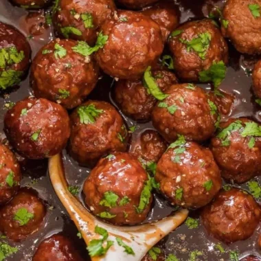 Delicious grape jelly meatballs served as a tasty appetizer on a platter.