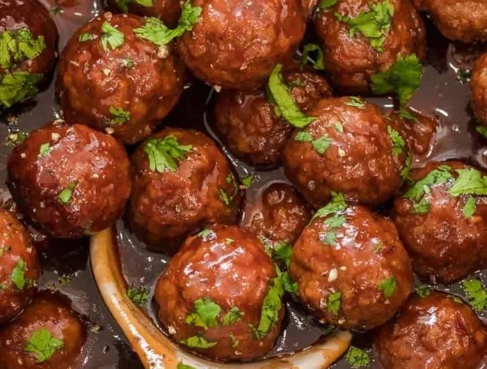 Delicious grape jelly meatballs served as a tasty appetizer on a platter.