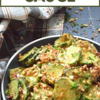 Cucumber salad drizzled with creamy peanut sauce served in a bowl
