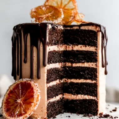 Delicious dark chocolate blood orange cake garnished with slices of blood orange.