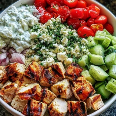 Delicious Greek Chicken Bowls with colorful vegetables and tzatziki sauce.