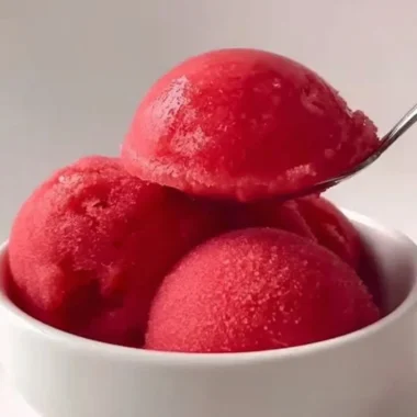 Delicious homemade strawberry sorbet served in a bowl with fresh strawberries