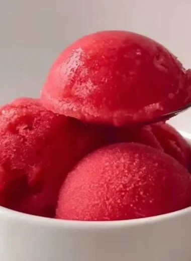 Delicious homemade strawberry sorbet served in a bowl with fresh strawberries