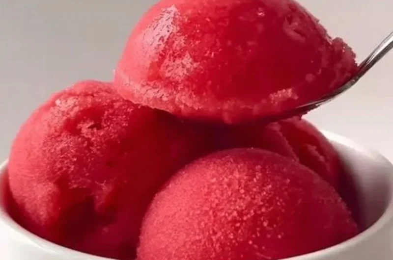 Delicious homemade strawberry sorbet served in a bowl with fresh strawberries