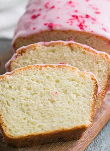 Delicious Key Lime Cake topped with raspberry glaze, showcasing vibrant colors.
