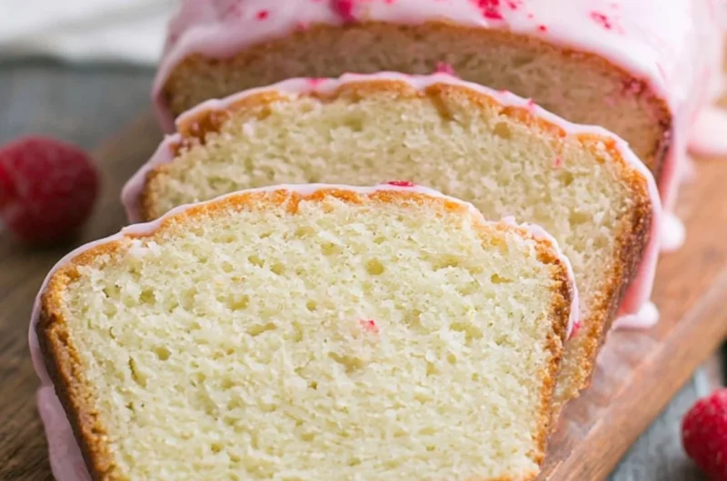 Delicious Key Lime Cake topped with raspberry glaze, showcasing vibrant colors.