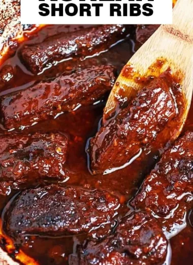 Deliciously plated Korean Braised Short Ribs with rich sauce and garnish.