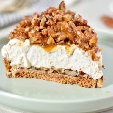 No-Bake Keto Pecan Pie Cheesecake with nuts and cream topping