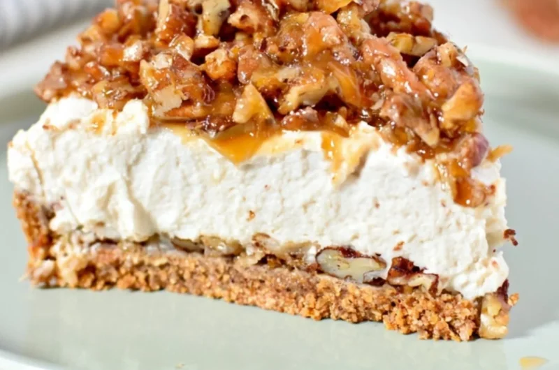 No-Bake Keto Pecan Pie Cheesecake with nuts and cream topping