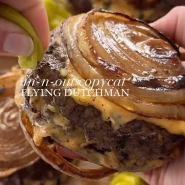 Onion-Wrapped Flying Dutchman plated with garnishes and condiments