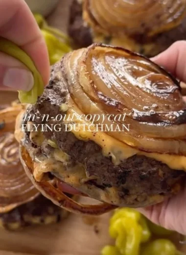 Onion-Wrapped Flying Dutchman plated with garnishes and condiments