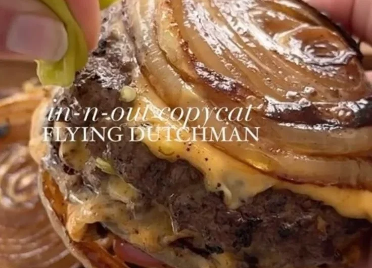 Onion-Wrapped Flying Dutchman plated with garnishes and condiments