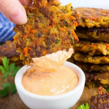 Golden brown potato fritters with red lentils served on a plate
