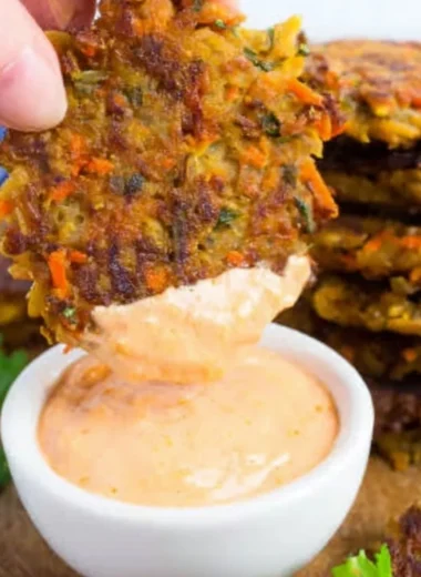Golden brown potato fritters with red lentils served on a plate