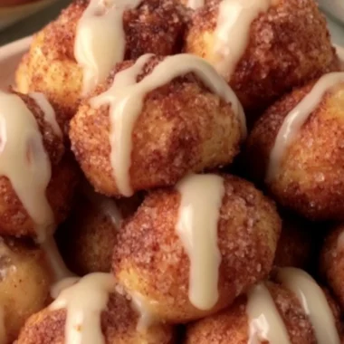 Quick cinnamon roll bites fresh out of the oven, topped with icing.