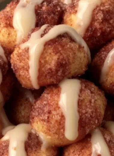 Quick cinnamon roll bites fresh out of the oven, topped with icing.