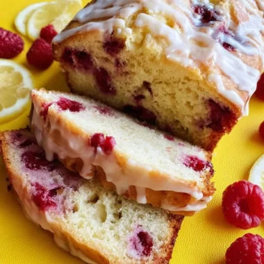 Sliced Raspberry Lemon Loaf with a drizzle of lemon glaze on a wooden board