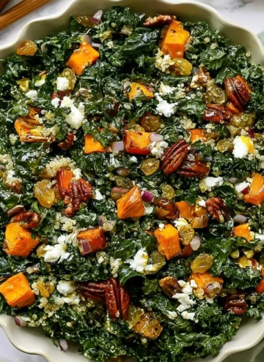 Roasted sweet potato kale salad served in a bowl with dressing and toppings