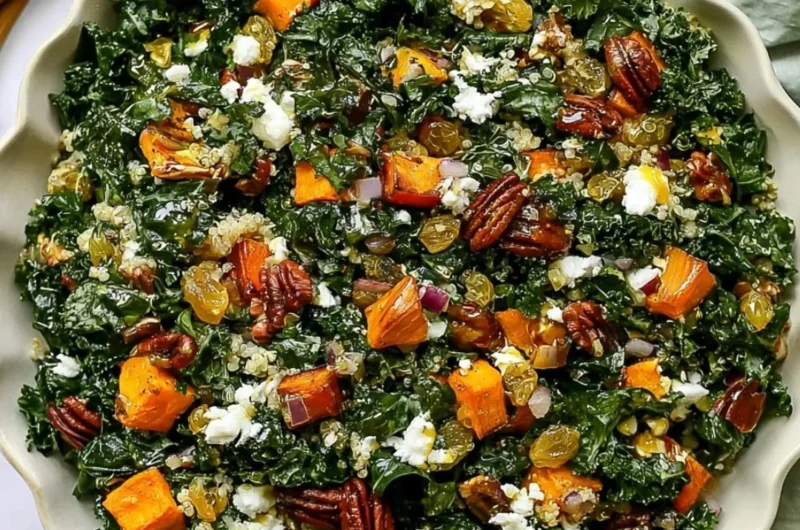 Roasted sweet potato kale salad served in a bowl with dressing and toppings