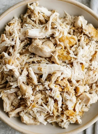 Bowl of shredded chicken ready for sandwiches and tacos