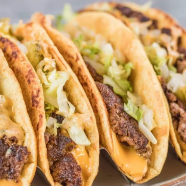 Delicious smash burger tacos showcasing juicy patties and vibrant toppings.