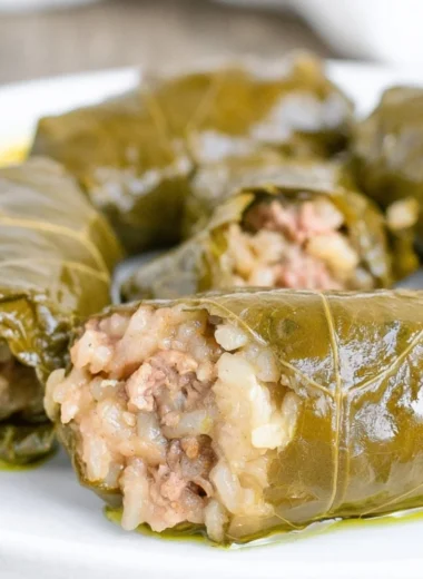 Delicious stuffed grape leaves filled with rice and herbs on a plate