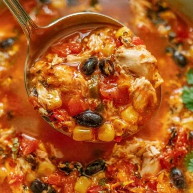 Bowl of Chicken Tortilla Soup topped with avocado and tortilla strips