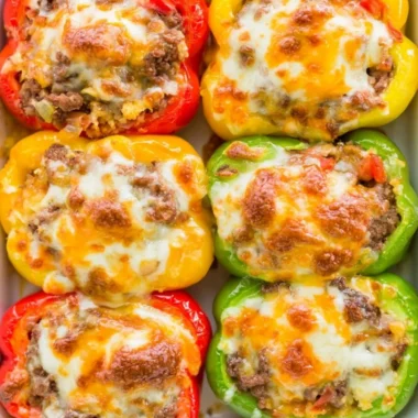 Cozy keto stuffed bell peppers filled with savory ingredients on a plate.