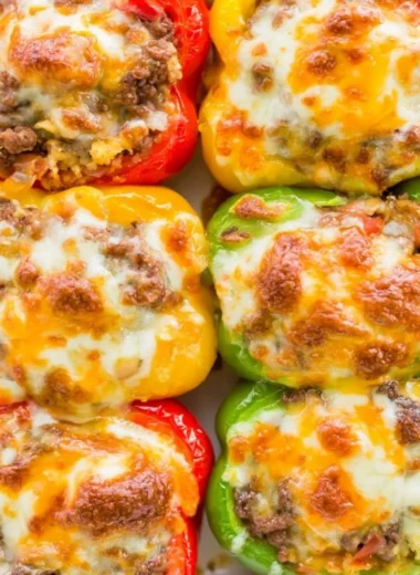 Cozy keto stuffed bell peppers filled with savory ingredients on a plate.