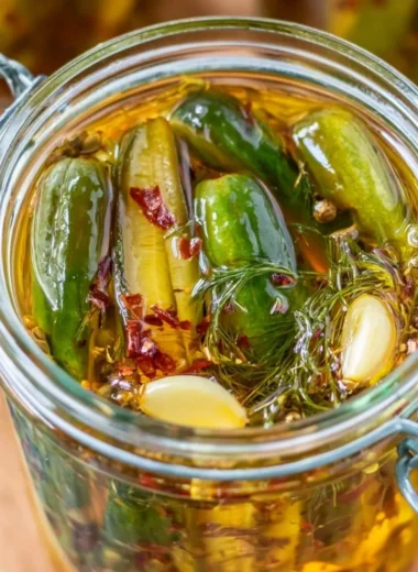 Jar of cozy smoked pickles with spices and herbs