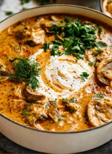 Delicious creamy Hungarian mushroom soup topped with fresh herbs in a bowl.