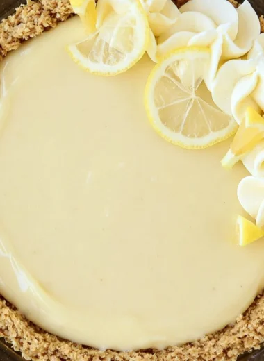 Slice of easy lemon cream pie on a plate with lemon garnishes