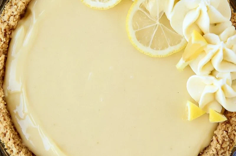 Slice of easy lemon cream pie on a plate with lemon garnishes