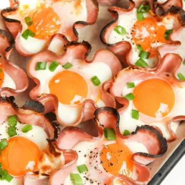 Ham and Cheese Egg Cups baked in muffin tin, featuring fluffy eggs and deli ham.