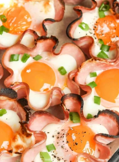 Ham and Cheese Egg Cups baked in muffin tin, featuring fluffy eggs and deli ham.