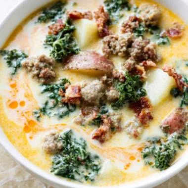 Bowl of Instant Pot Tuscan Soup garnished with fresh herbs and bread