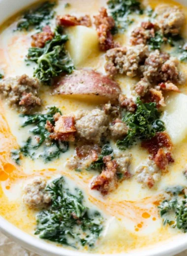 Bowl of Instant Pot Tuscan Soup garnished with fresh herbs and bread