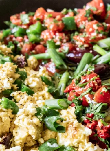 Mediterranean breakfast bowl with fresh vegetables, olives, and eggs