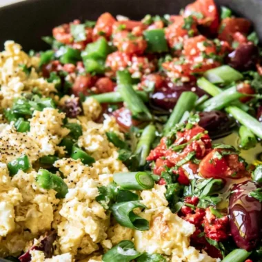 Colorful Mediterranean breakfast bowl with fresh vegetables and grains