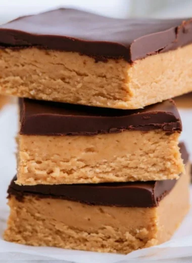 No-bake peanut butter buckeye bars topped with chocolate and peanut butter drizzle.
