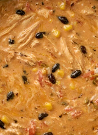 Creamy chicken tortilla soup in a slow cooker with fresh toppings.