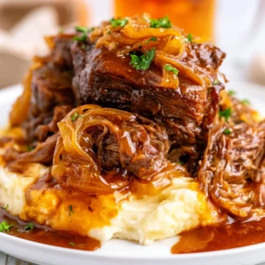 Delicious slow cooker French onion pot roast with melted cheese and herbs