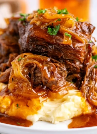 Delicious slow cooker French onion pot roast with melted cheese and herbs