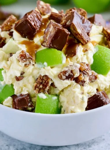 Delicious Snickers Apple Salad with apples, caramel, and chocolate pieces