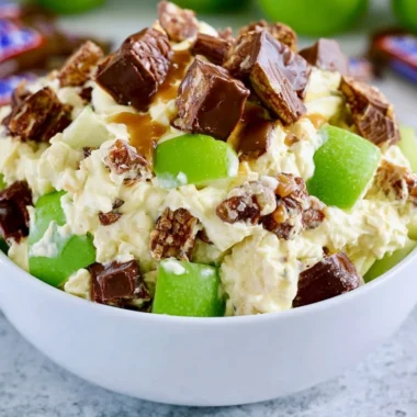 Delicious Snickers Apple Salad with apples, caramel, and whipped cream