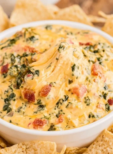 Delicious spinach dip served in a bowl with tortilla chips