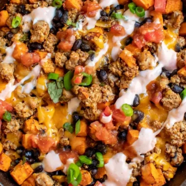 Cozy ground turkey and sweet potato taco skillet topped with fresh ingredients.